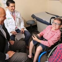 Care team with child in wheelchair with parent